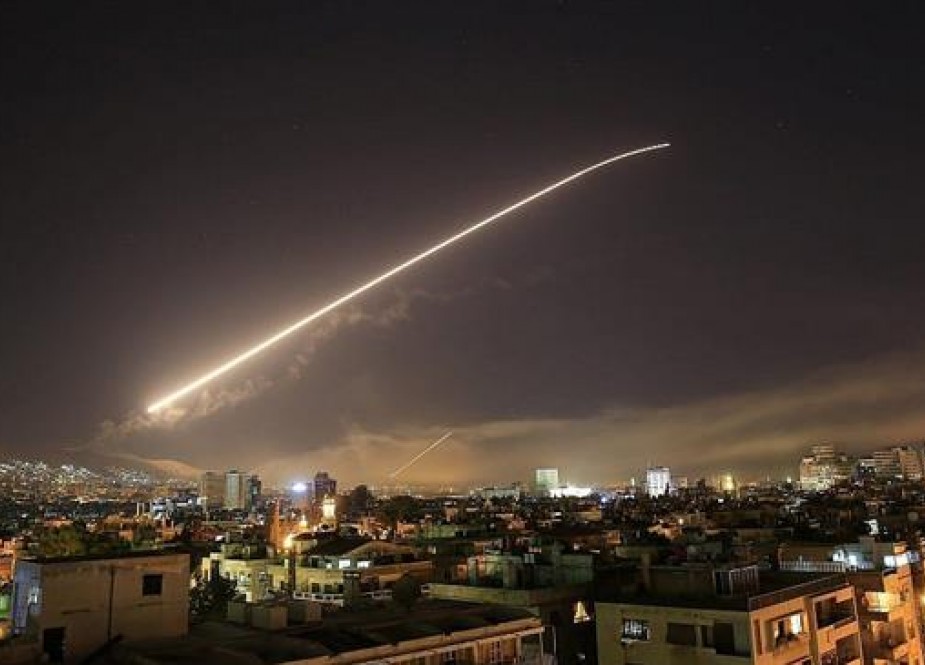 Missiles streak across the Damascus skyline following an attack..jpg