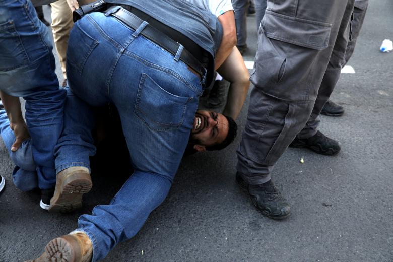 A protestor is detained by Israeli security forces during a demonstration against the opening of the new U.S. embassy in Jerusalem, in Jerusalem May 14, 2018.