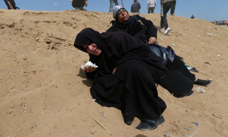 Female Palestinian demonstrators react to tear gas fired by Israeli troops during a protest against the U.S. embassy move to Jerusalem and ahead of the 70th anniversary of Nakba, at the Israel-Gaza border in the southern Gaza Strip.
