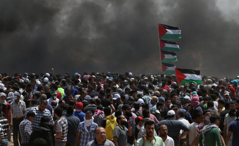 Palestinian demonstrators gather during a protest against U.S. embassy move to Jerusalem and ahead of the 70th anniversary of Nakba, at the Israel-Gaza border in the southern Gaza Strip.