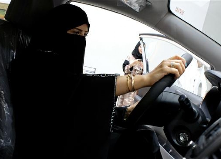 Saudi woman checks a car at the first automotive showroom.jpg