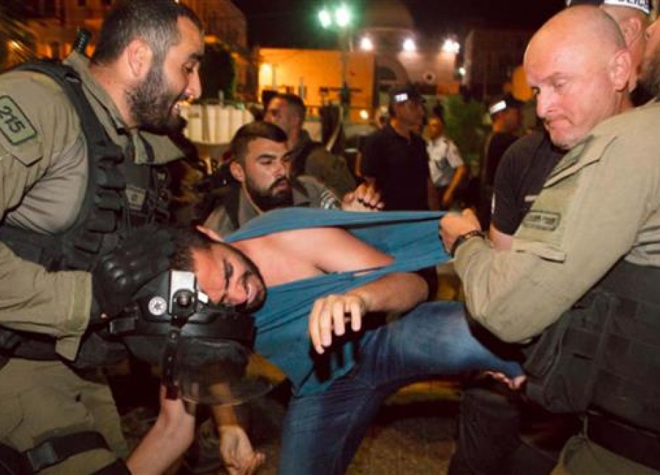 Israeli policemen arrest a protester in Haifa on May 18, 2018.