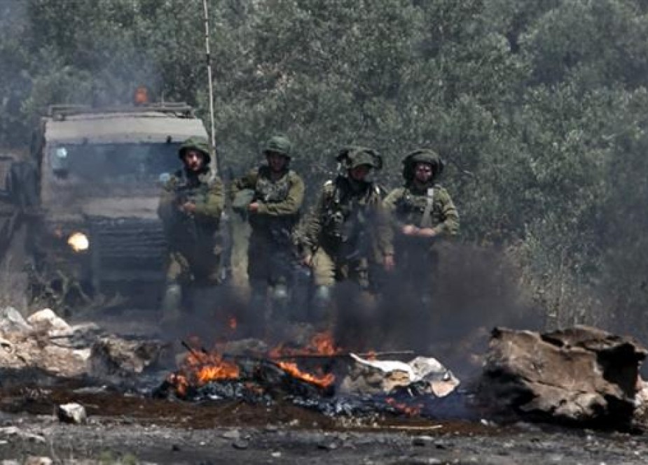 Israeli soldiers take position during a weekly demonstration against the expropriation of Palestinian land by Israel in the village of Kfar Qaddum, near Nablus in the occupied West Bank, on May 11, 2018. (Photo by AFP)
