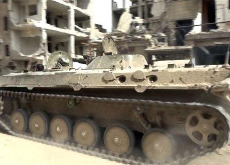 A handout picture released by the official Syrian Arab News Agency (SANA) on May 10, 2018 shows a Syrian army infantry-fighting vehicle (IFV) advancing through a street in al-Hajar al-Aswad as Syrian forces push against Daesh Takfiri terrorist group in the area on the southern outskirts of the capital Damascus. (Photo by AFP)