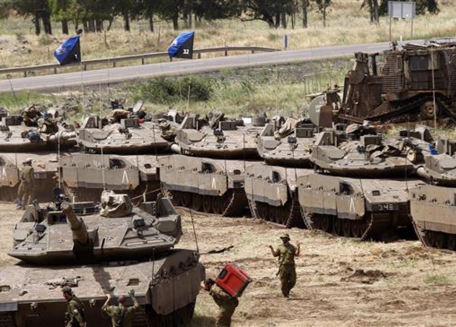 Israeli soldiers walk by Merkava Mark IV tanks during a military drill in the Israeli-annexed Golan Heights on May 1, 2018. (Photo by AFP)