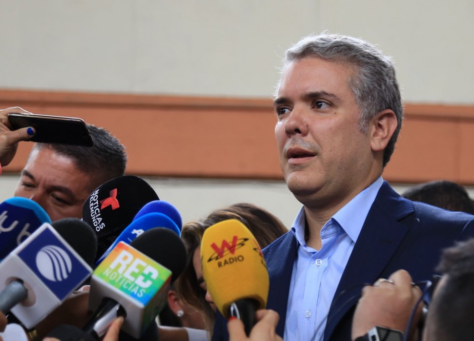 Colombian presidential candidate Ivan Duque (C), for the Democratic Center Party, Press conference, after winning the first round of the Colombian presidential election, in Bogota on May 27, 2018.