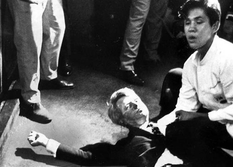Busboy Juan Romero crouches with US Democratic presidential candidate Robert F. Kennedy, who had been fatally wounded by a gunman after finishing his speech upon winning the California Democratic primary on June 5, 1968 at the Ambassador Hotel in Los Angeles.