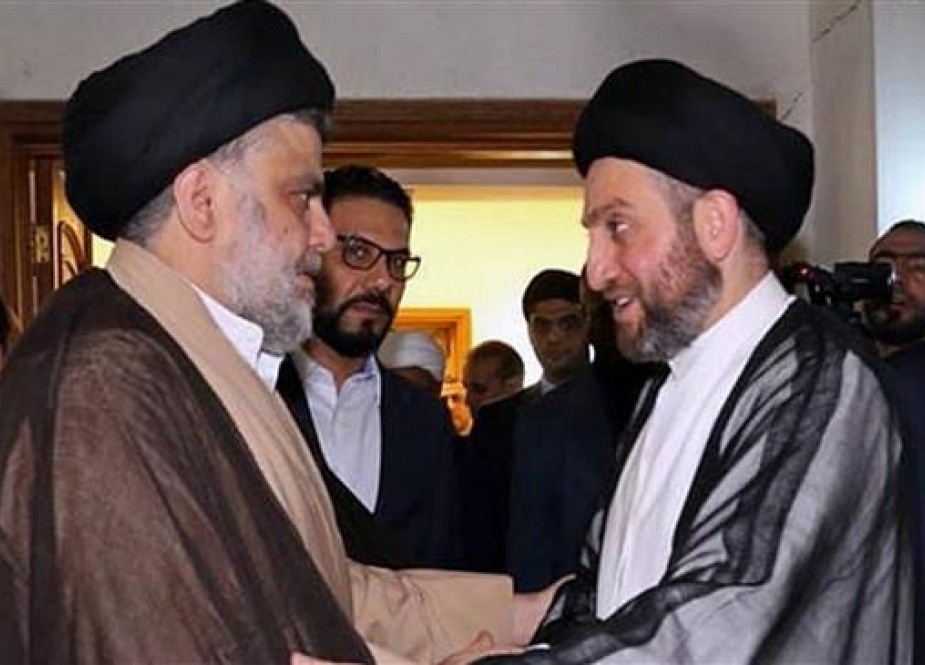 In this photo provided by the Sadr Media Office, Shia cleric Muqtada al-Sadr (L) greets Ammar al-Hakim on his arrival for a meeting in Baghdad, Iraq, May 22, 2018. (Via AP)