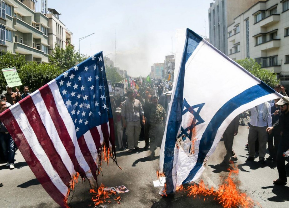 Iranians burn US and Israel flags during a protest marking the annual Quds Day on the last Friday of the holy month of Ramadan in Tehran, Iran.