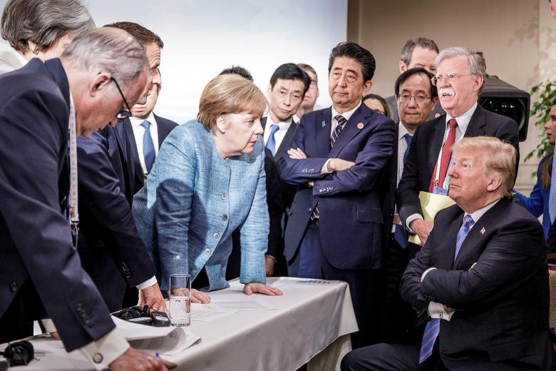 German Chancellor Angela Merkel speaks to U.S. President Donald Trump during the second day of the G7 meeting in Charlevoix city of La Malbaie, Quebec, Canada.