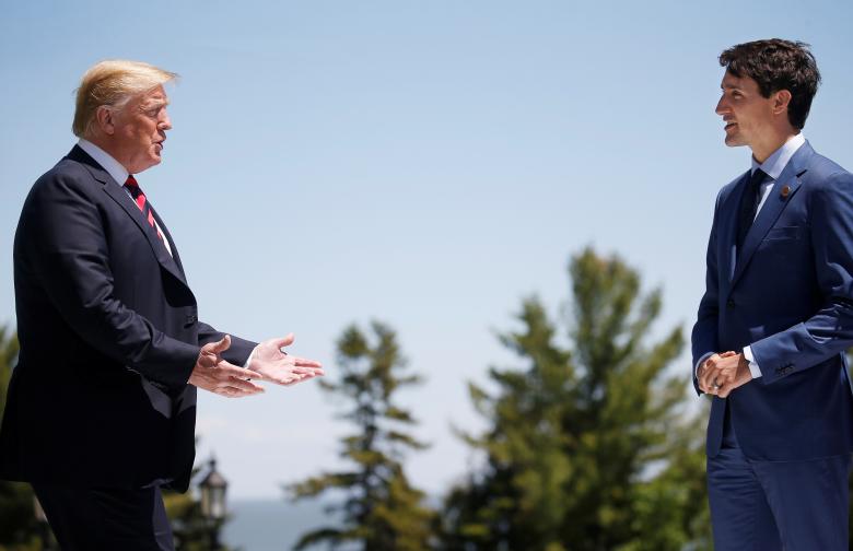 U.S. President Donald Trump approaches Canada's Prime Minister Justin Trudeau as he arrives at the G7 Summit in Charlevoix, Quebec.