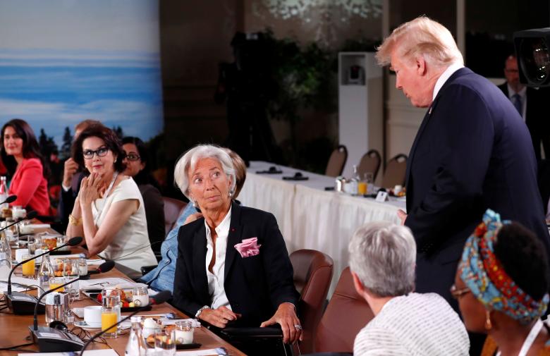 U.S. President Donald Trump arrives as Managing Director of the International Monetary Fund Christine Lagarde looks up while they attend a G7 and Gender Equality Advisory Council meeting.