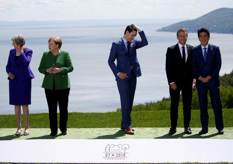 British Prime Minister Theresa May, German Chancellor Angela Merkel, Canada's Prime Minister Justin Trudeau, France's President Emmanuel Macron and Japanese Prime Minister Shinzo Abe wait for U.S. President Donald Trump to join them for a family photo.