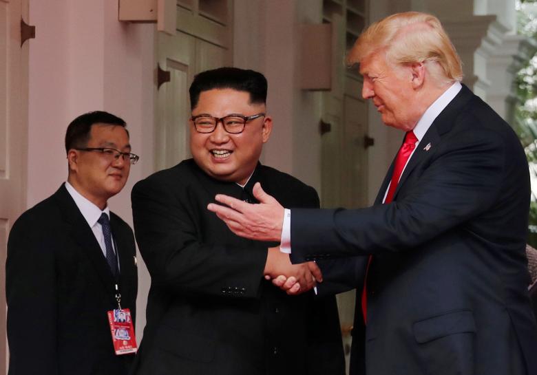 President Donald Trump shakes hands with North Korea's leader Kim Jong Un at the Capella Hotel on Sentosa island in Singapore.