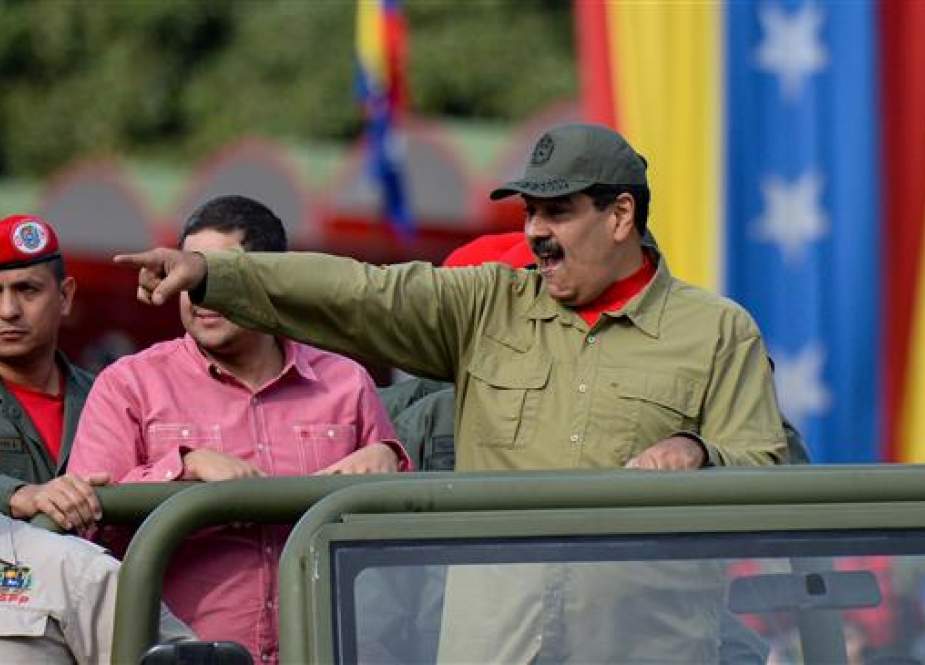 Venezuelan President Nicolas Maduro gestures as he arrives for a military parade to commemorate the 16th anniversary of the return of the late president Hugo Chavez to power after a failed coup d’état, at the National Heroes Avenue in the capital, Caracas, on April 13, 2018. (Photo by AFP)