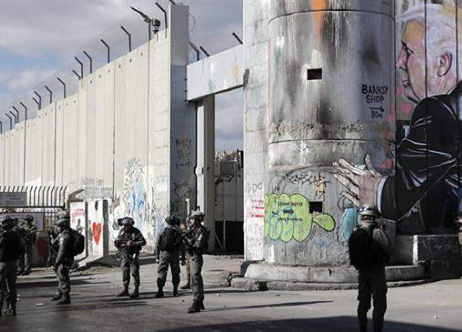 Israeli forces stand near the controversial separation wall.jpg
