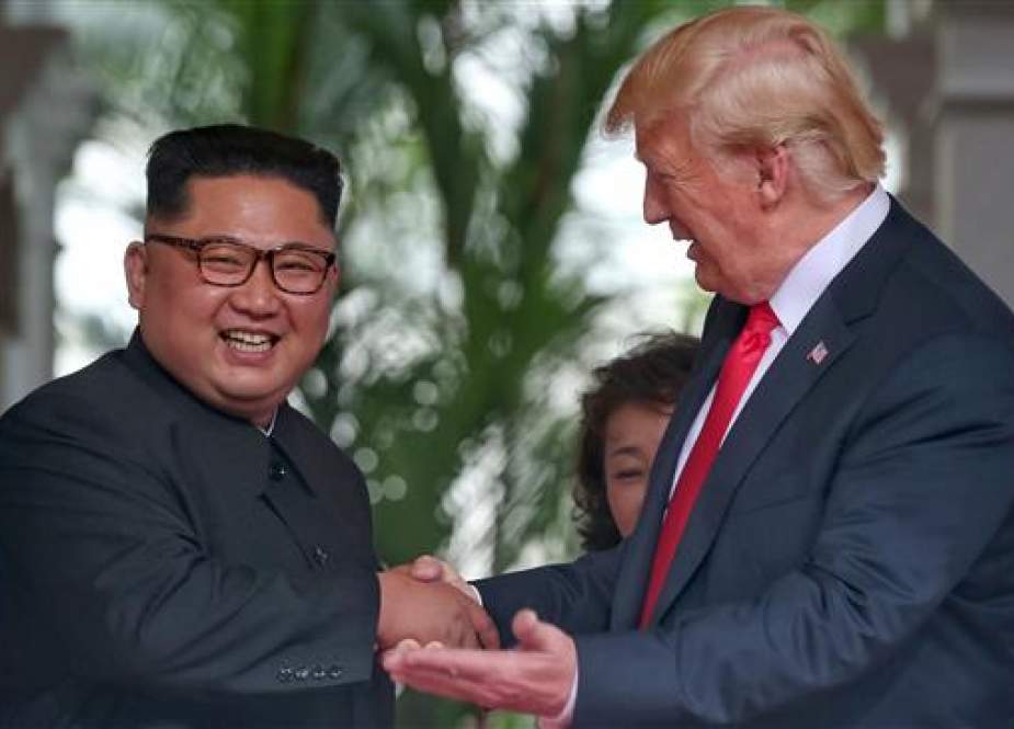 North Korean leader Kim Jogn-un (L) shaking hands with US President Donald Trump in Singapore.jpg
