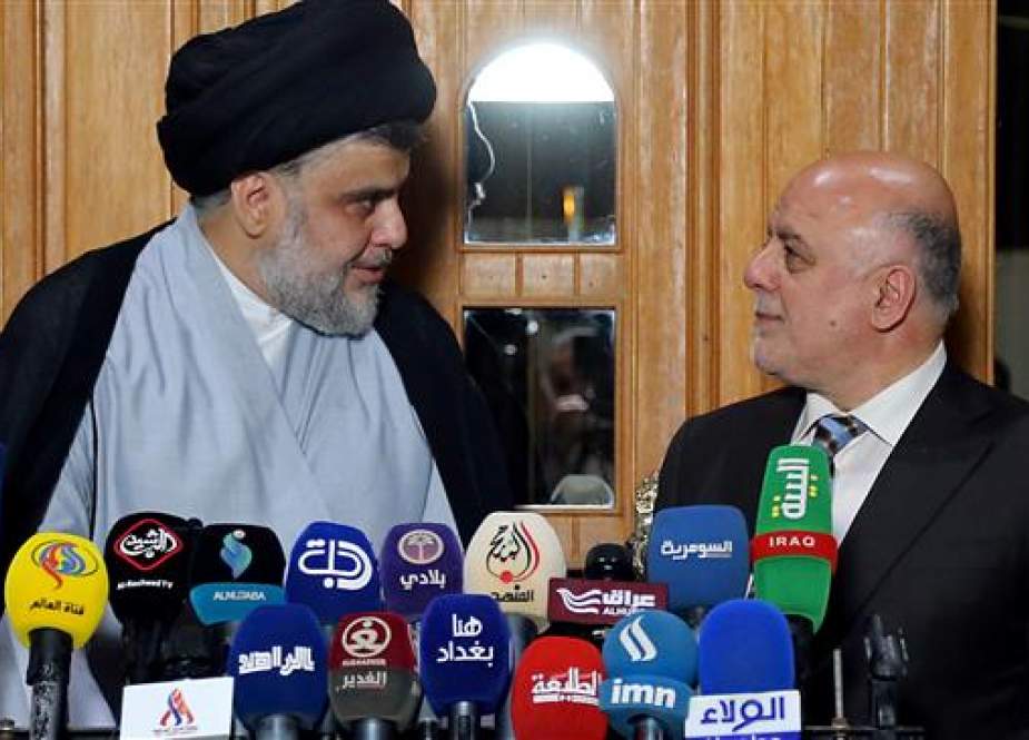 Iraqi Prime Minister Haider al-Abadi (R) attend a press conference with Iraqi cleric and leader Moqtada al-Sadr in Najaf on June 23, 2018. (Photo by AFP)