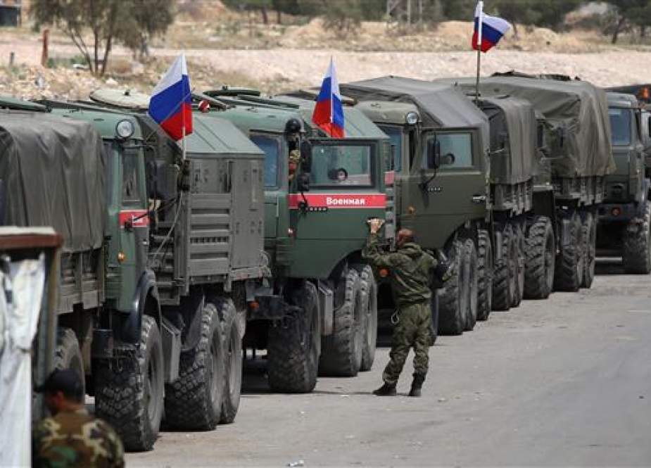 Russian soldiers wait at the entrance of the al-Wafideen Camp.jpg