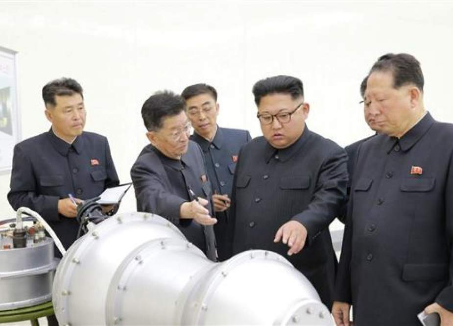 Kim Jong-un meets nuclear weapons scientists including Hong Sung-mu (right) and Ri Hong-sop (second left) in this undated photo.