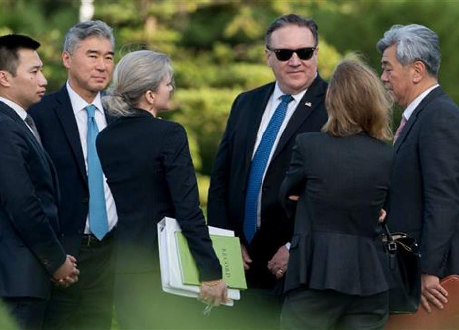 US Secretary of State Mike Pompeo (3rd R) speaks with his aides outside the Park Hwa Guest House after a meeting with Kim Yong Chol, a North Korean senior ruling party official and former intelligence chief, in Pyongyang on July 6, 2018. (Photo by AFP)