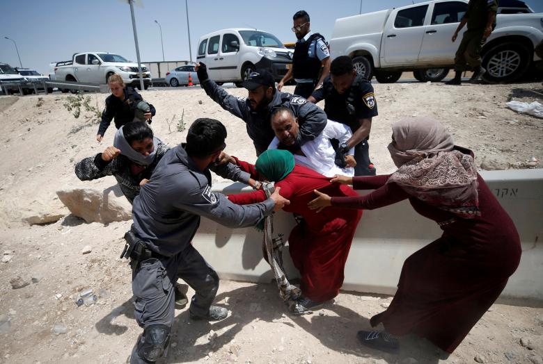 Israeli policemen try to detain Palestinians in the Bedouin village of al-Khan al-Ahmar near Jericho in the occupied West Bank.