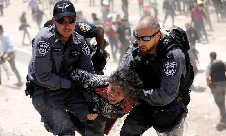Israeli policemen detain a Palestinian girl in the Palestinian Bedouin village of al-Khan al-Ahmar near Jericho in the occupied West Bank.