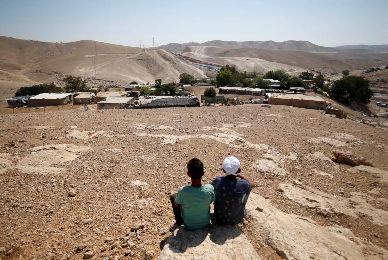 Palestinian boys sit in the Bedouin village of al-Khan al-Ahmar near Jericho in the occupied West Bank.