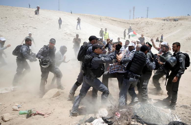 Israeli policemen scuffle with Palestinians in the Bedouin village of al-Khan al-Ahmar near Jericho in the occupied West Bank.