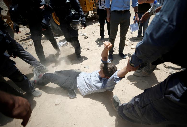 Israeli policemen detain a protester in the Palestinian Bedouin village of al-Khan al-Ahmar near Jericho in the occupied West Bank.