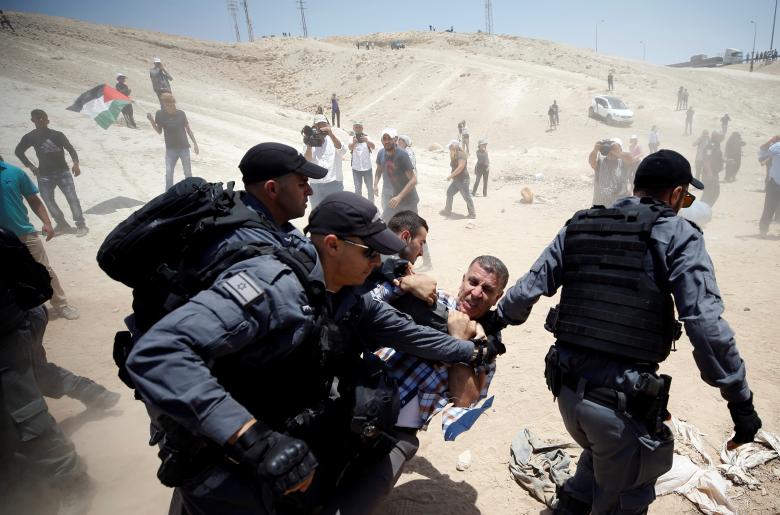 Israeli policemen detain a Palestinian in the Bedouin village of al-Khan al-Ahmar near Jericho in the occupied West Bank.