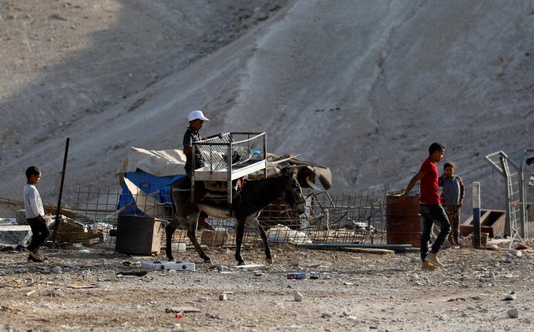 A Palestinian Bedouin boy rides a donkey in al-Khan al-Ahmar near Jericho in the occupied West Bank.