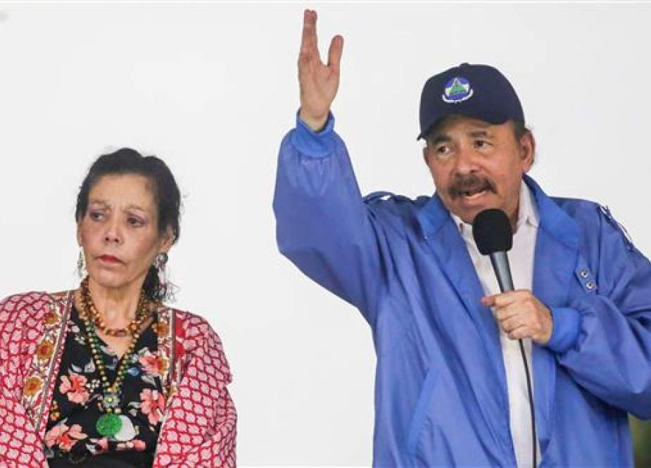Nicaraguan President Daniel Ortega (R), accompanied by his wife, Vice President Rosario Murillo, speaks to supporters during a pro-government rally in Managua, Nicaragua, on July 7, 2018. (Photo by AFP)