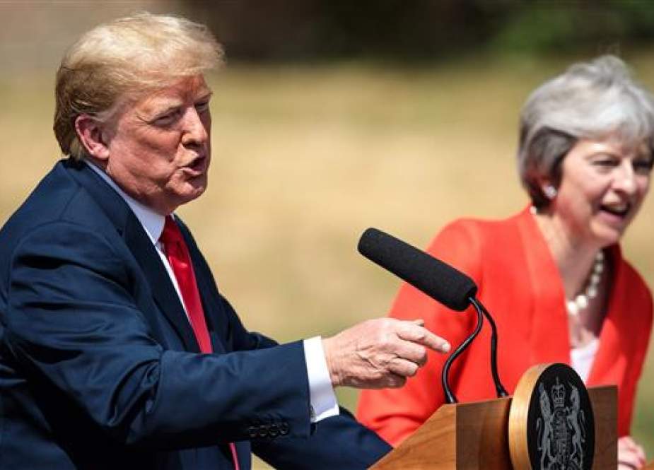 US President Donald Trump (L) gestures as he speaks next to Britain