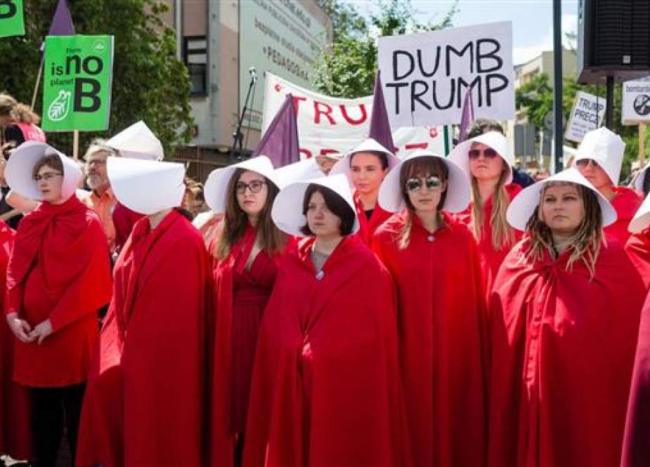 US President Donald Trump was greeted by a crowd of women dressed as handmaids inspired by Margaret Atwood’s dystopian novel The Handmaid’s Tale in Poland, June 2017.