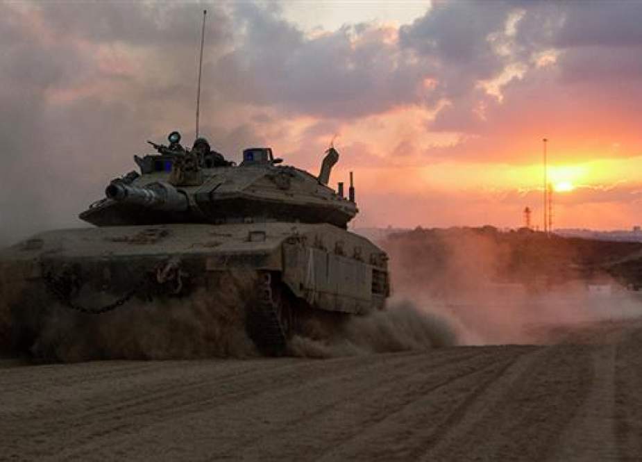 An Israeli Merkava tank rolls back from the Gaza Strip to an army deployment near Israel