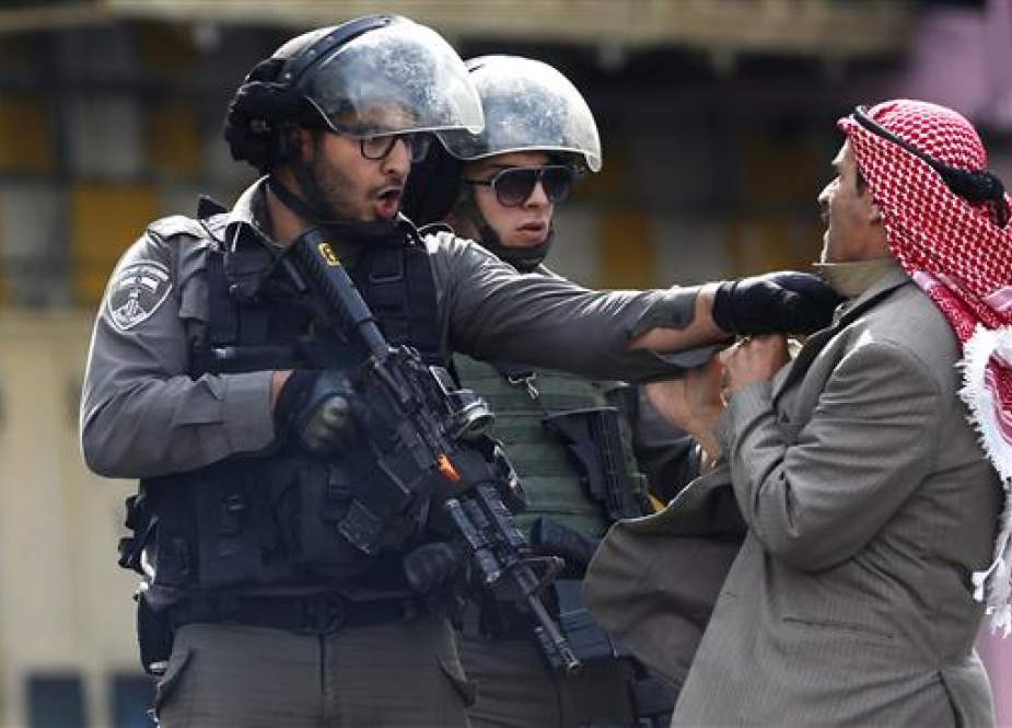Palestinian man being pushed by an Israeli policemen in al-Khalil (Hebron).jpg