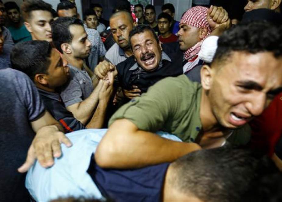 Palestinian relatives react as they arrive at the morgue of the al-Shifa hospital in Gaza City where the body of Mohammed Badwan was brought after he was shot dead by Israeli forces during protests along the border east of Gaza City. (Photo by AFP)