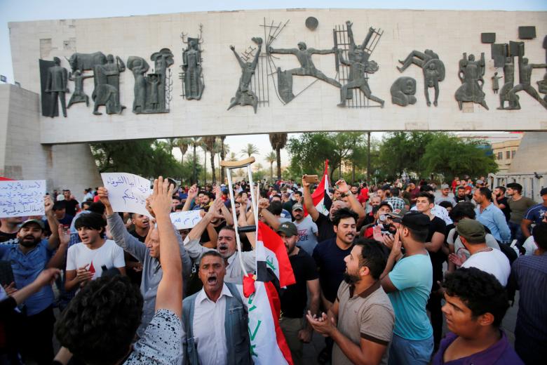 Iraqis shout slogans during a protest in Baghdad, July 16.
