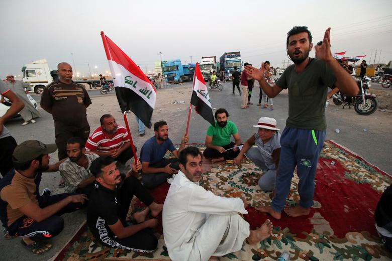 Protesters block the road to Iraq's Umm Qasr port, south of Basra, July 13.