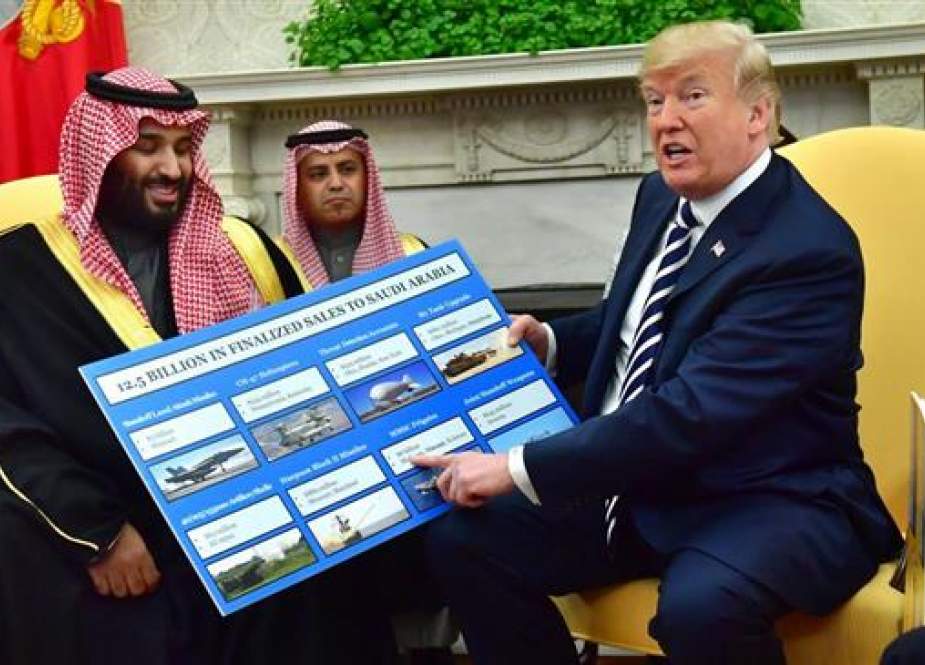 President Donald Trump holds up a chart of military hardware sales as he meets with Crown Prince Mohammed bin Salman of Saudi Arabia in the Oval Office at the White House, March 20, 2018. (Photo by EFE)