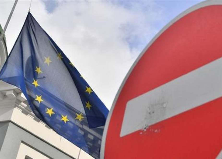 An EU map is pictured behind a Do Not Enter traffic sign.