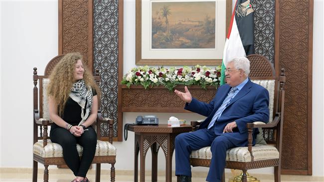 Palestinian President Mahmoud Abbas, right, meets with Palestinian teenager Ahed Tamimi after she was released from an Israeli prison, in Ramallah in the occupied West Bank, July 29, 2018.
