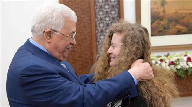 Palestinian President Mahmoud Abbas, left, meets with Palestinian teenager Ahed Tamimi after she was released from an Israeli prison, in Ramallah in the occupied West Bank, July 29, 2018.