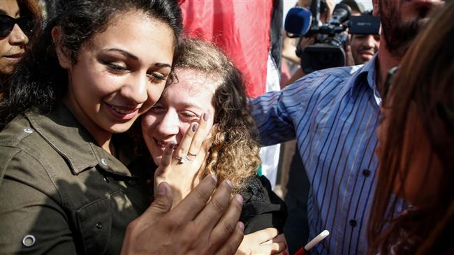 Palestinian teenager Ahed Tamimi, center, is welcomed by relatives and supporters after she was released from an Israeli prison, Nabi Saleh village, the occupied West Bank, July 29, 2018.