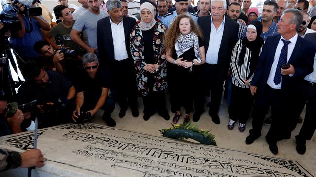 Palestinian teenager Ahed Tamimi, center with long hair, visits the tomb of late Palestinian President Yasser Arafat after she was released from an Israeli prison, Ramallah, the occupied West Bank, July 29, 2018.