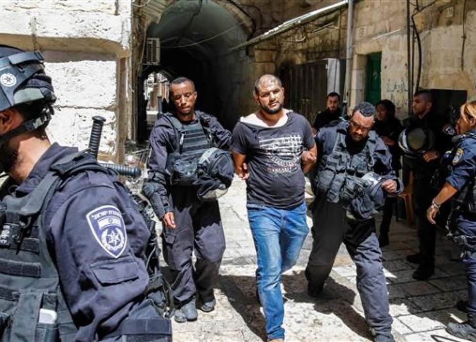 Israeli forces take into custody a Palestinian protester, who was arrested during clashes at the Aqsa Mosque compound in the Old City of Jerusalem al-Quds on July 27, 2018. (Photo by AFP)