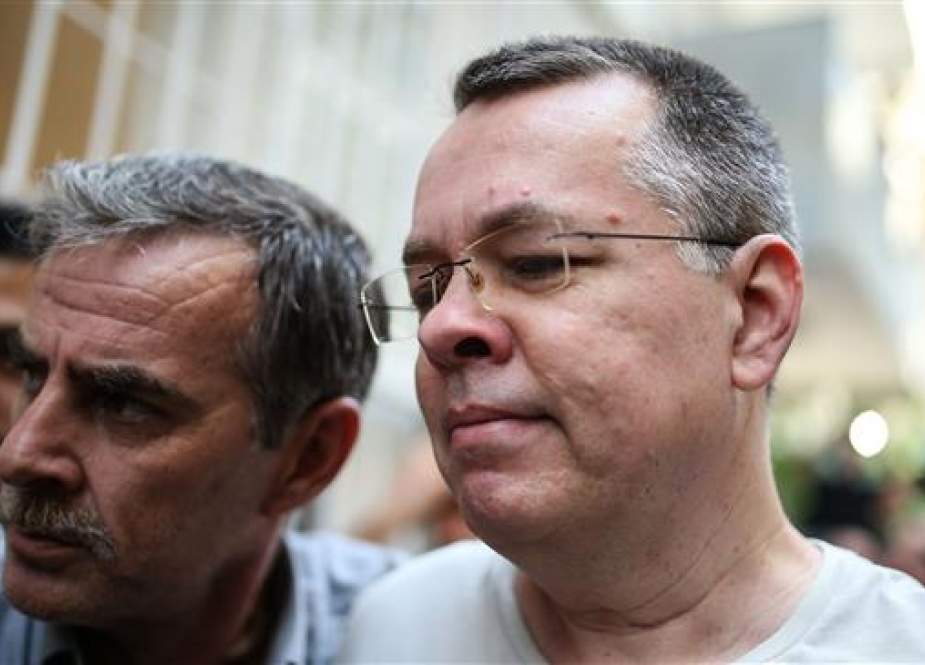 US pastor Andrew Craig Brunson (R) escorted by Turkish plain clothes police officers arrives at his house on July 25, 2018 in Izmir. (AFP photo)