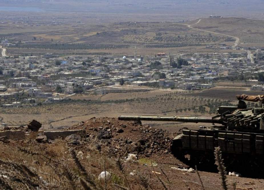 A Syrian positioned near the border fence with the Israeli-occupied Golan Heights