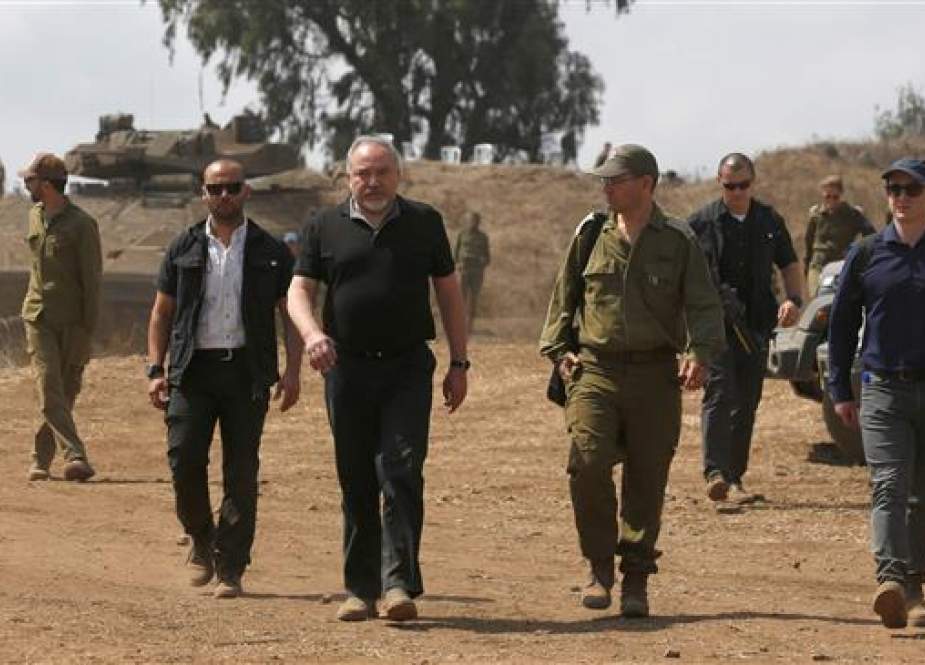 Avigdor Lieberman, the Israeli minister for military affairs, (C) walks with army officers during a visit to the Israeli-occupied Golan Heights on August 7, 2018. (Photo by AFP)